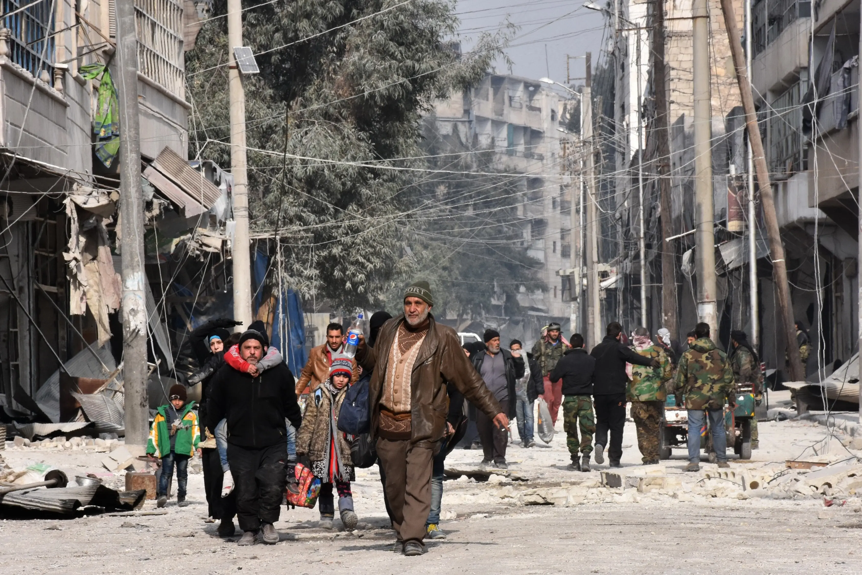 Residents flee the al-Salihin nieghborhood in east Aleppo