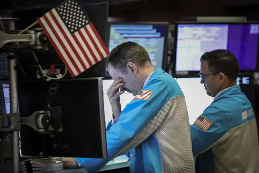 Traders and financial professionals work ahead of the closing bell on the floor of the New York Stock Exchange.