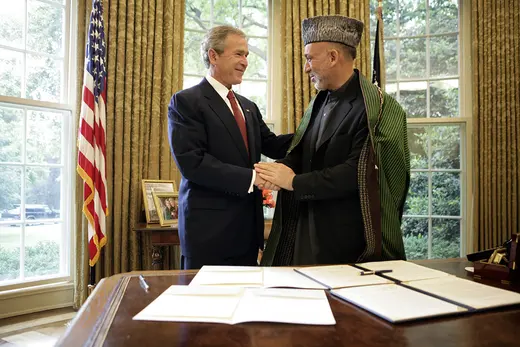 President Bush and President Karzai shaking hands in the Oval Office.