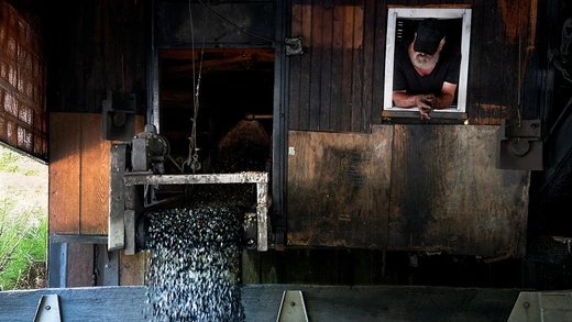 Larry Renninger, 58, watches as a truck is loaded with anthracite coal at Superior Coal Preparation Plant in Hegins, Pennsylvania, U.S.