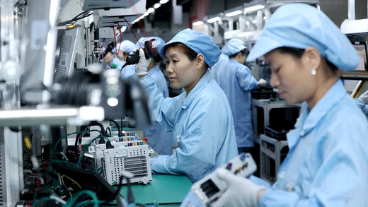 Workers work on a production line manufacturing smart automotive central control navigation products at a factory of Beidou Intelligent Connected Vehicle Technology Co. (BICV) in the High Tech Industrial Development Zone in Suqian, Jiangsu Province, China April 9, 2025.