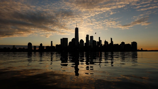  The skyline of lower Manhattan and One World Trade Center is reflected in the Hudson River as the sun rises in New York City on March 5, 2023, as seen from Jersey City, New Jersey. 