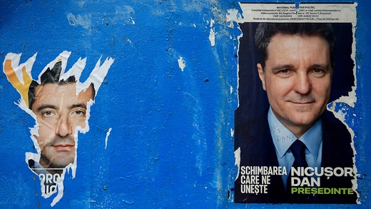 A torn out poster featuring presidential candidate George Simion is seen next to one of Nicușor Dan, with the writing “It’s Dan”, ahead of the second round of the presidential elections, in Bucharest, Romania, May 16, 2025.