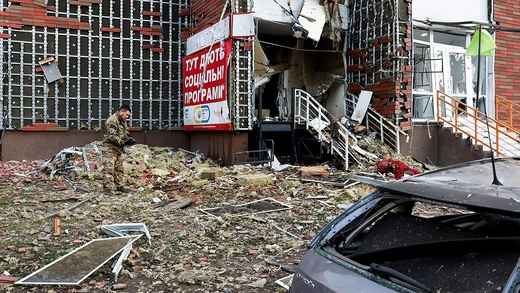 An investigator works next to a damaged apartment building at the site of a Russian drone strike, amid Russia's attack on Ukraine, in Kyiv, Ukraine June 10, 2025. 